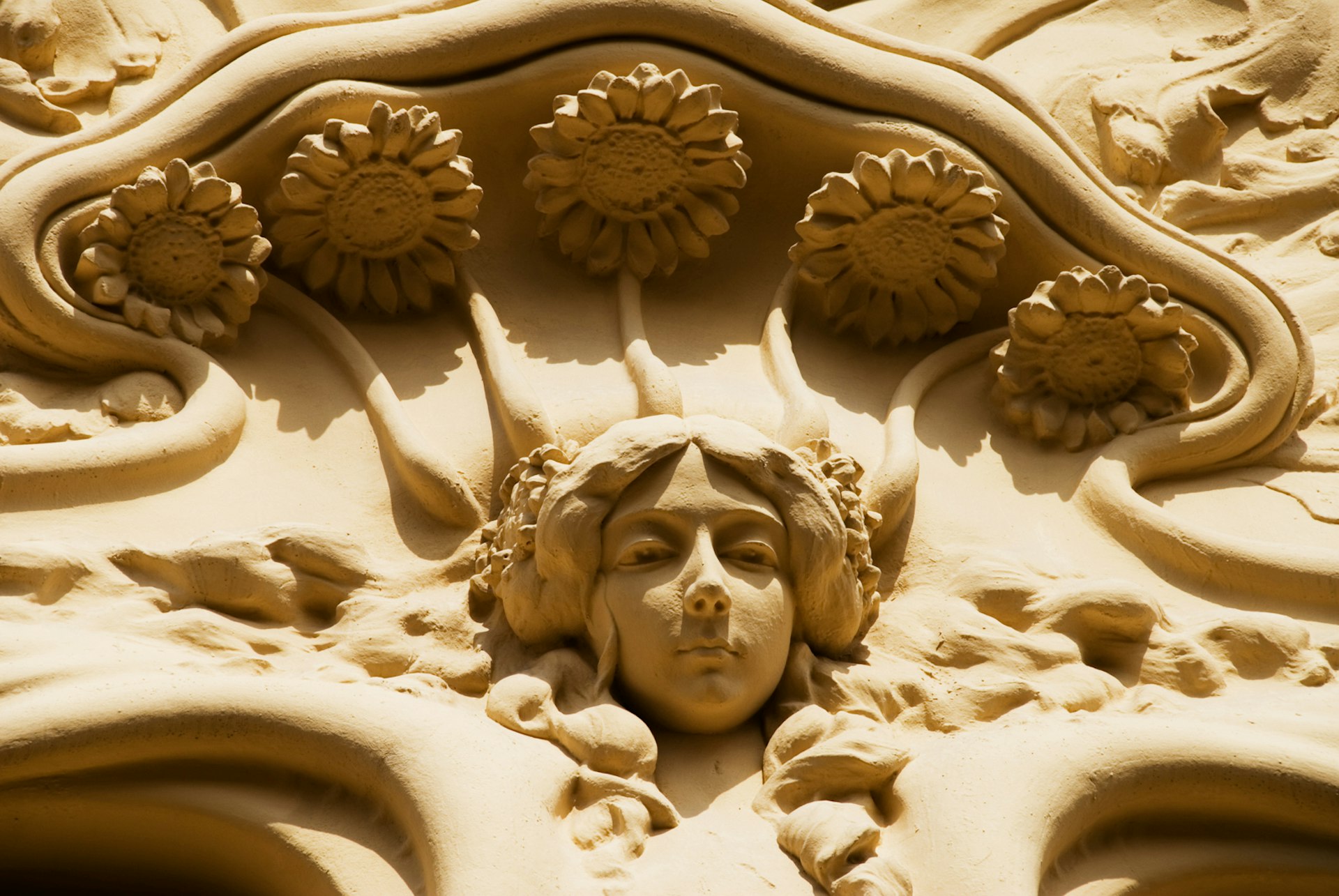 Detail of the Sociedad General de Autores y Editores showing a human face and other intricate designs