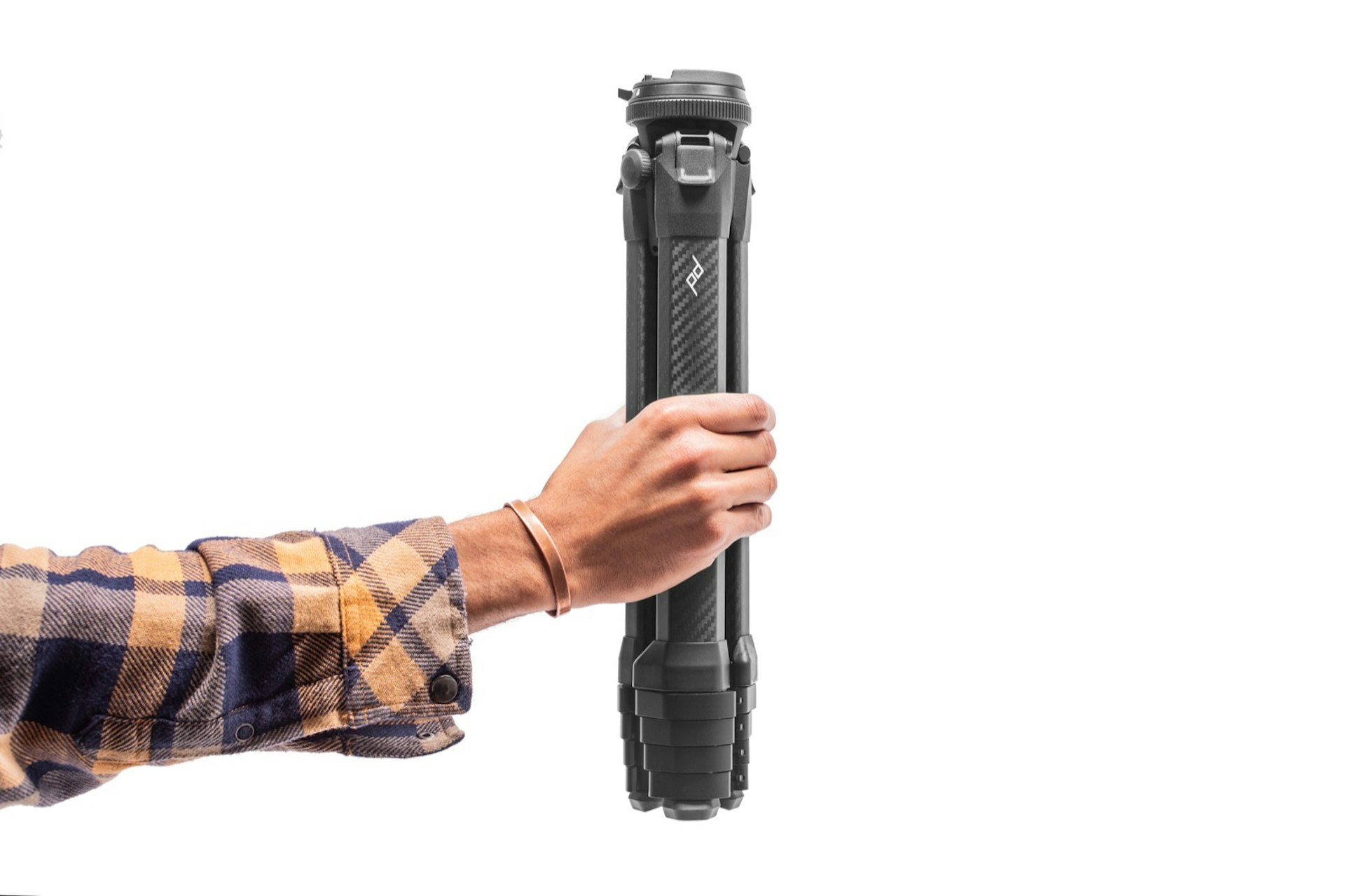 A person holds a compact tripod