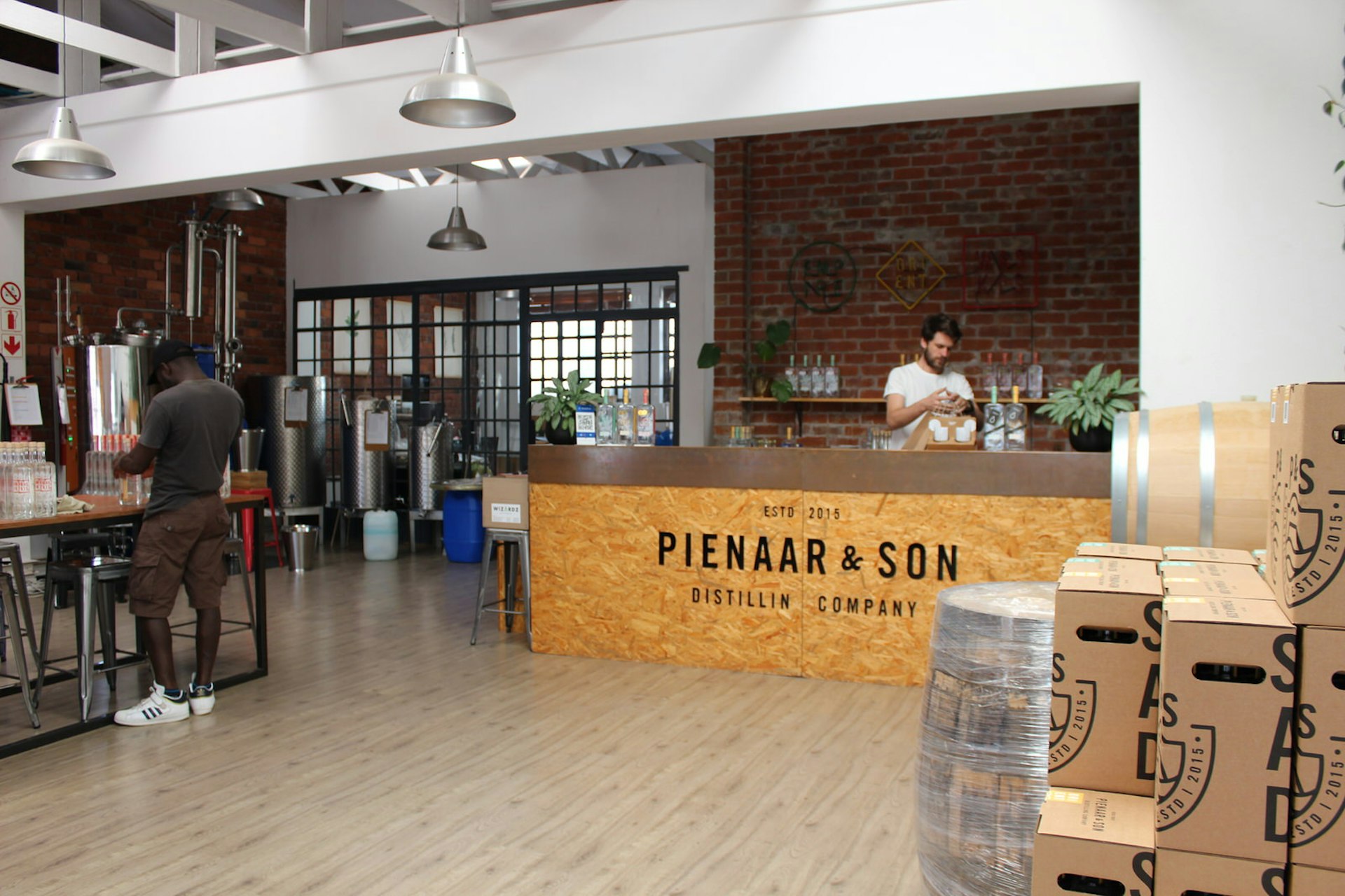 Cape Town gin - Part warehouse, part bar, the interior of Pienaar & Sons is a mix of wooden floors, chipboard furniture, brick walls, loft-like crittall windows and small-scale distillery equipment