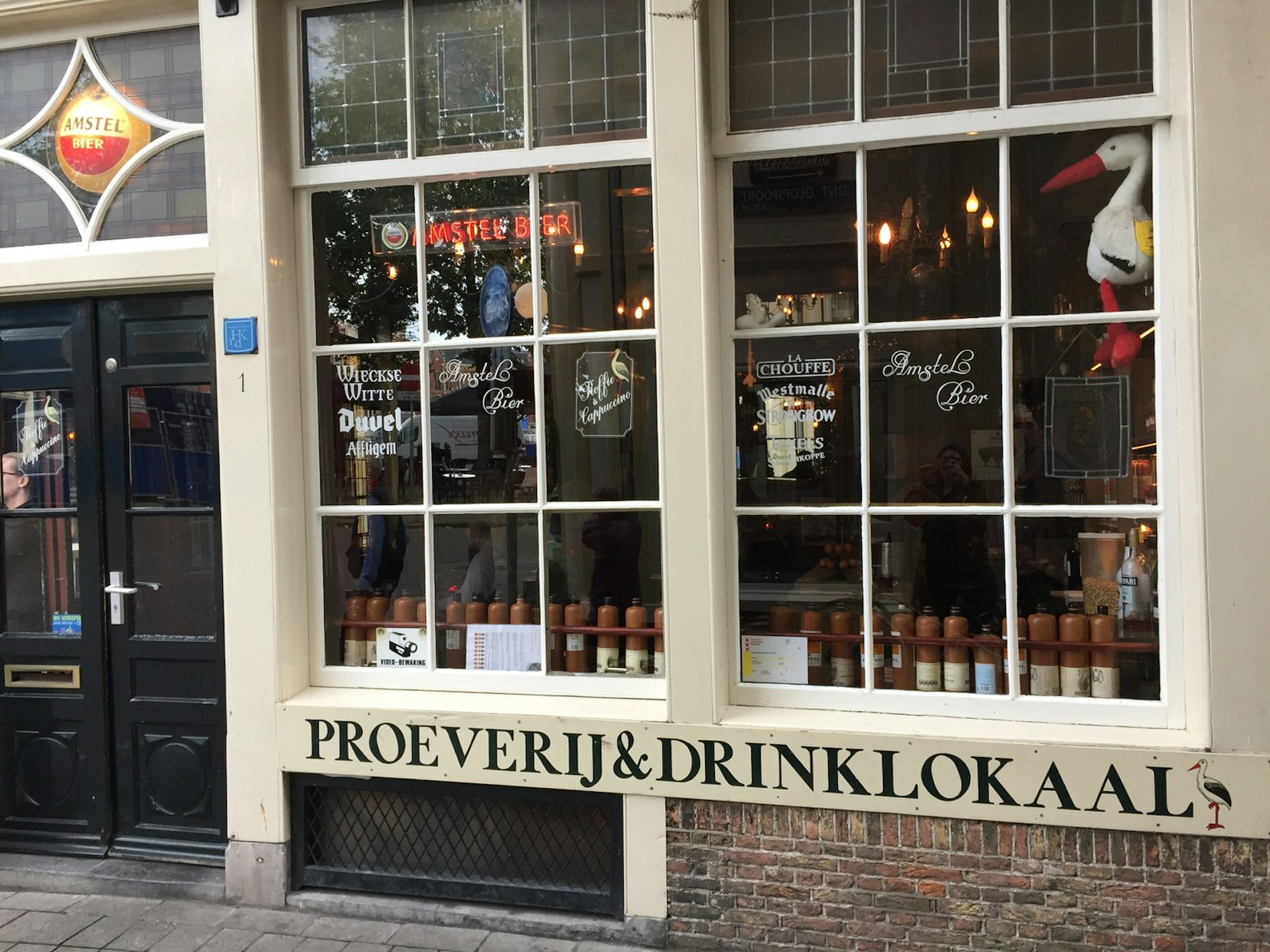 An exterior image of this little brown cafe, with large wooden-framed windows