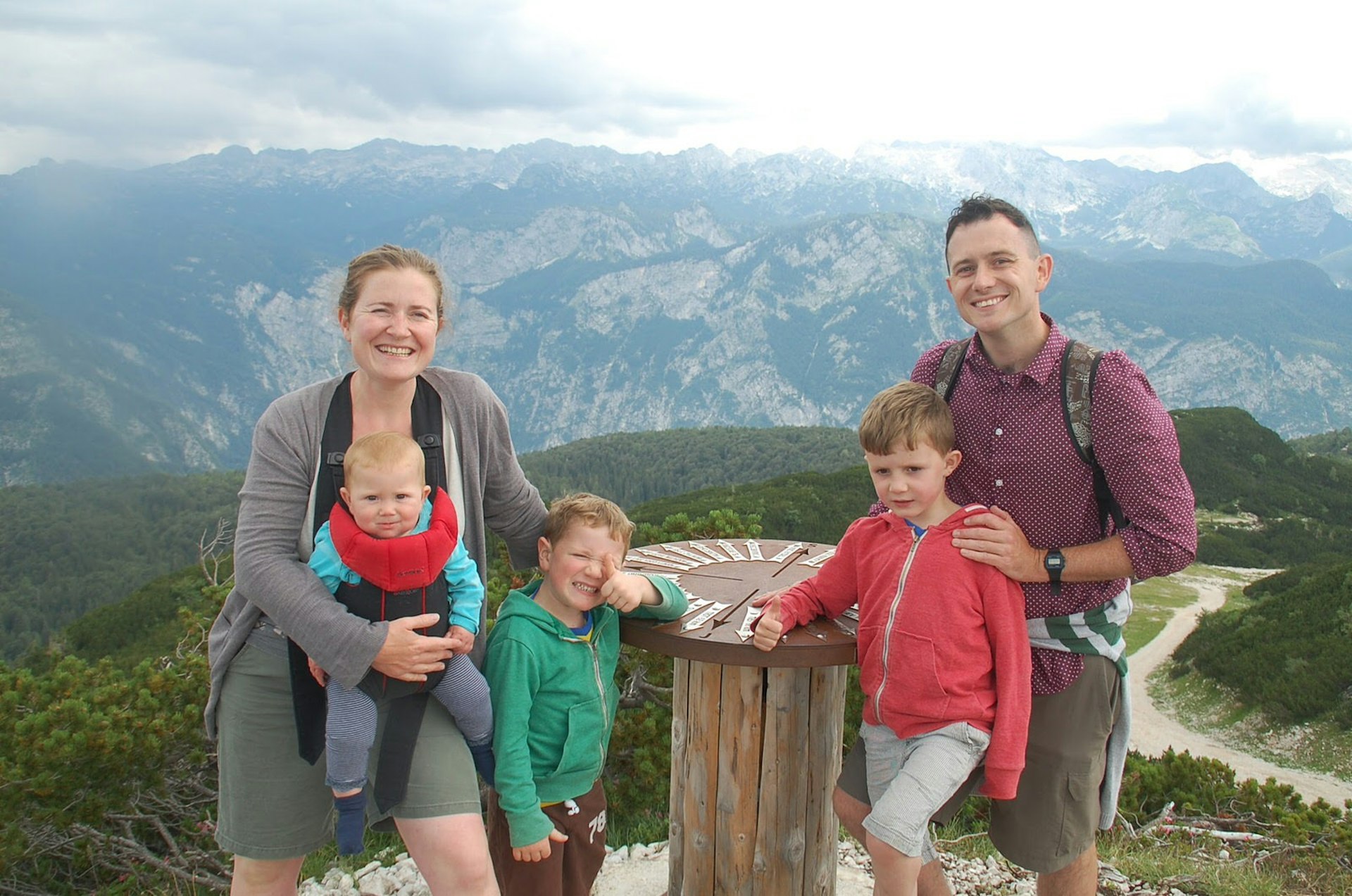 Imogen, her husband Tom and their three young children stand in front of a mountainous view in Slovenia