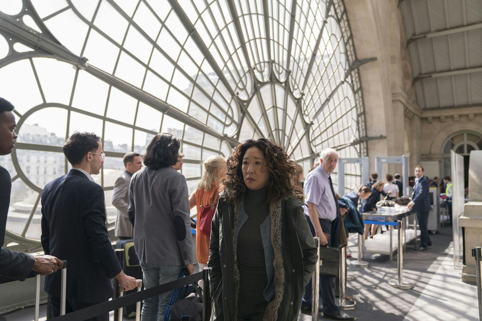 Eve (played by Sandra Oh) looks worried in Paris's Gare du Nord, with a huge window and a queue for the Eurostar security scanner behind her. This scene from Killing Eve season two was actually filmed at the nearby Gare de l'Est.