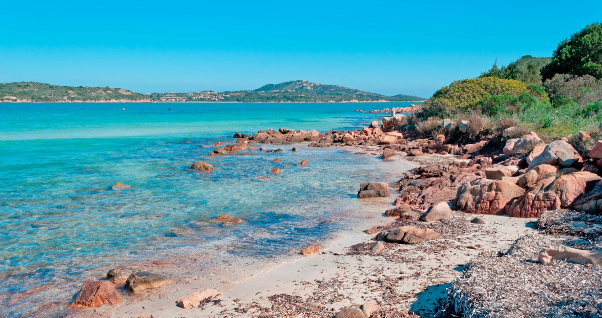 Azure waters near a rocky shore; best things to do in Sardinia