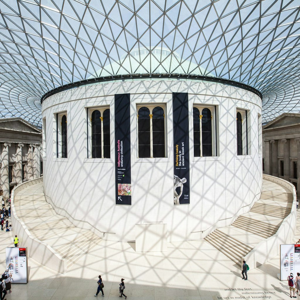 The central hall of the British Museum is a large round white space flooded with light from the glass ceiling