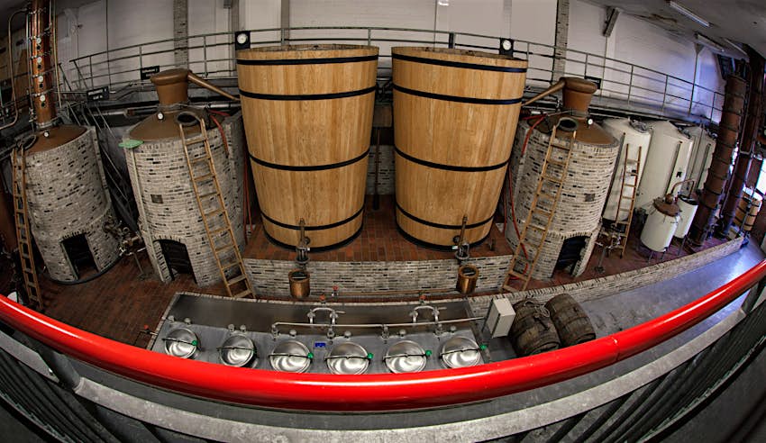 The interior of a historic distillery in Schiedam where two large wooden brewing tanks are on view