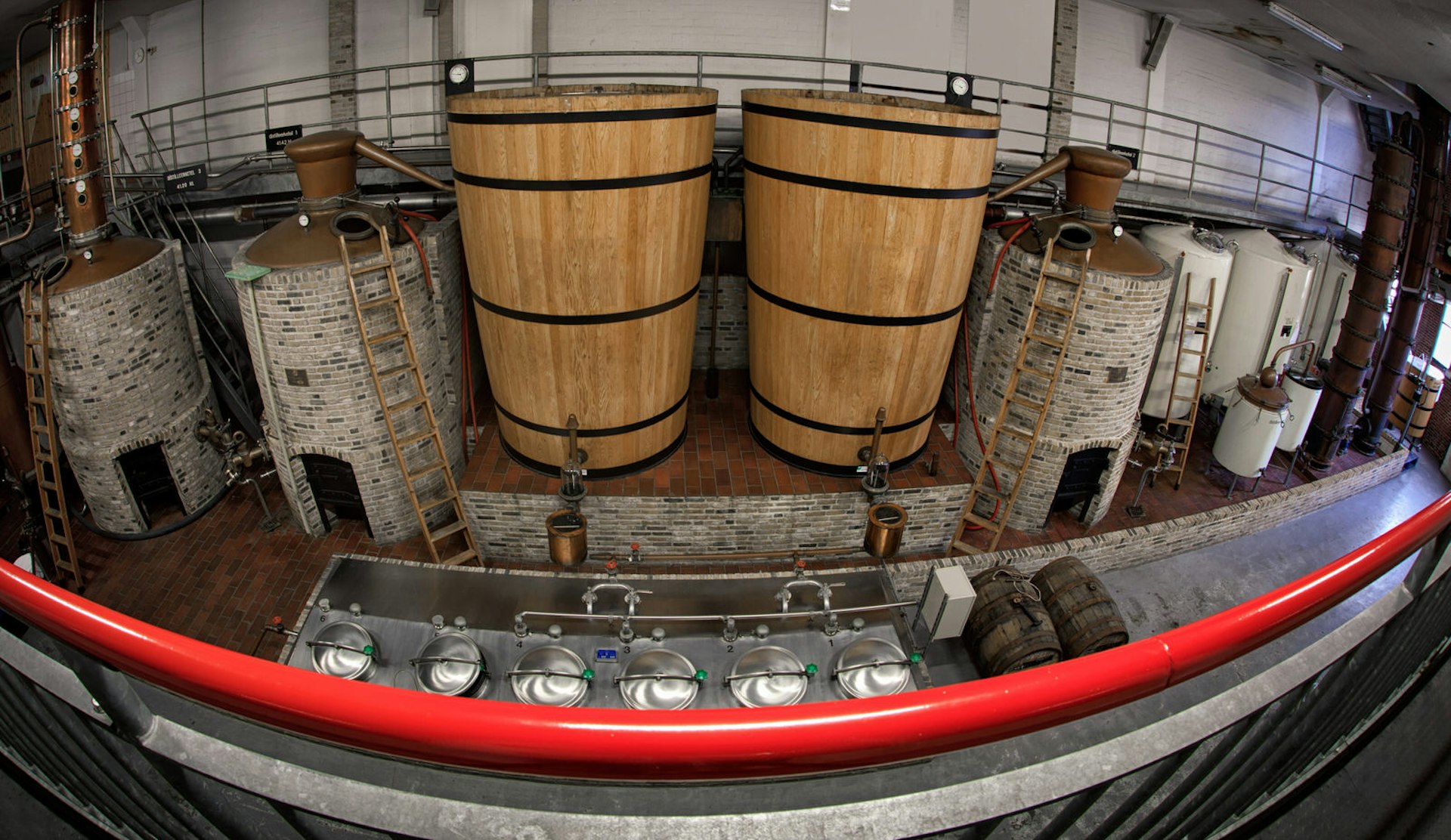 The interior of a historic distillery in Schiedam where two large wooden brewing tanks are on view