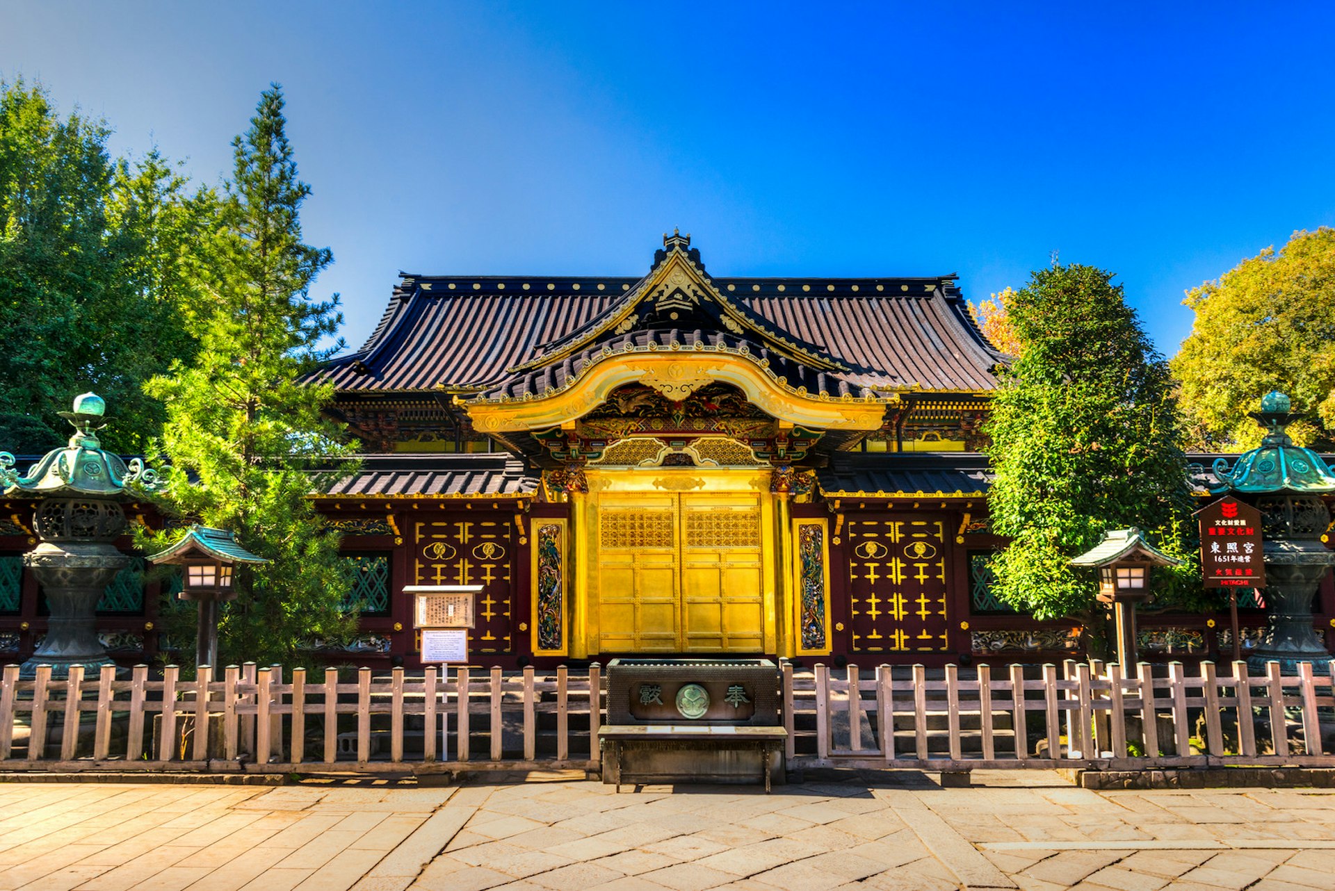 The gilded shrine of Ueno Tōshō-gū, a small, ornate Japanese shrine that's brown in colour with a magnificent gold door