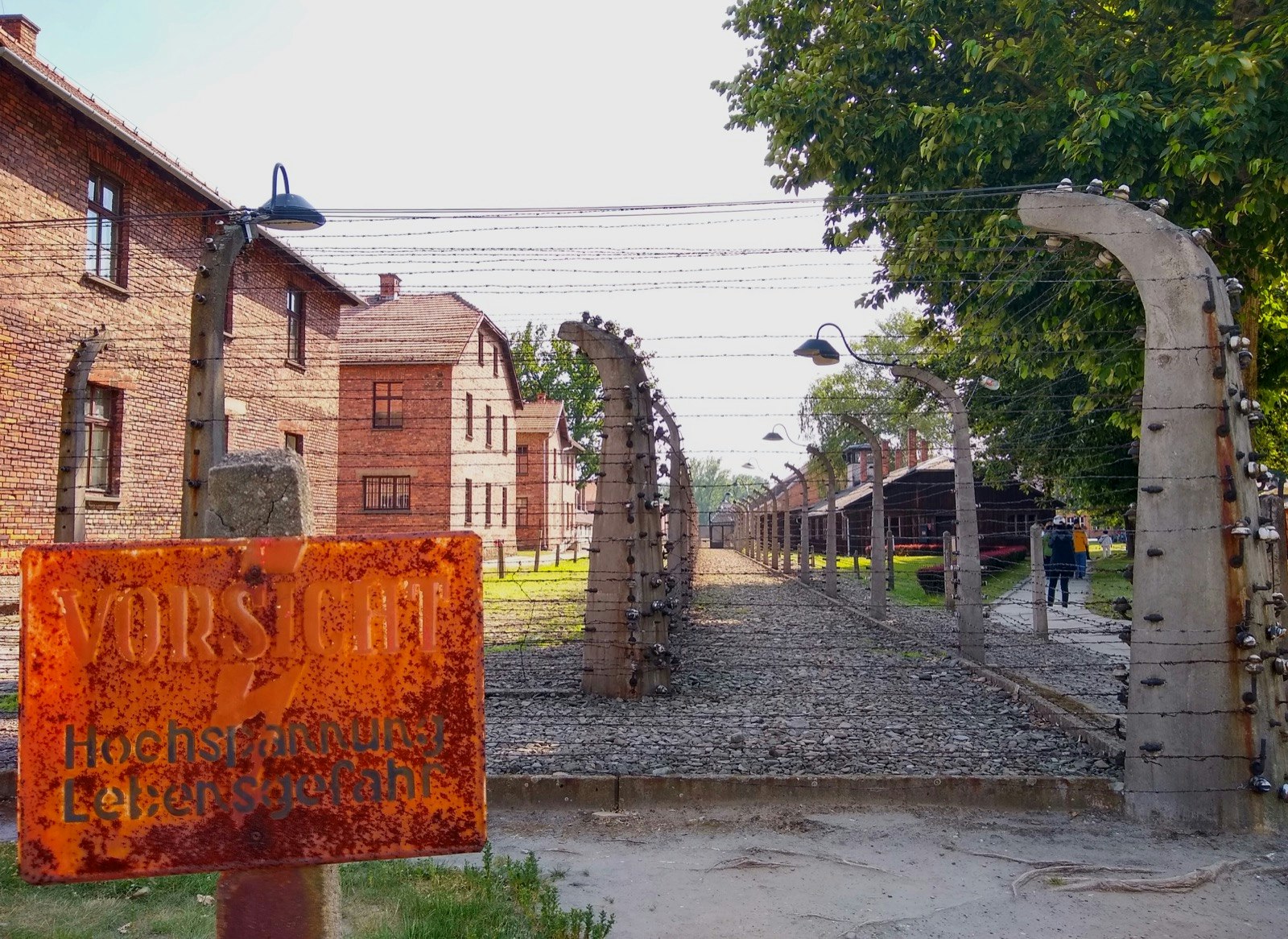 A rusted sign marks a barbed-wire gate leading to the concentration camp at Auschwitz; Krakow Jewish cultural revival