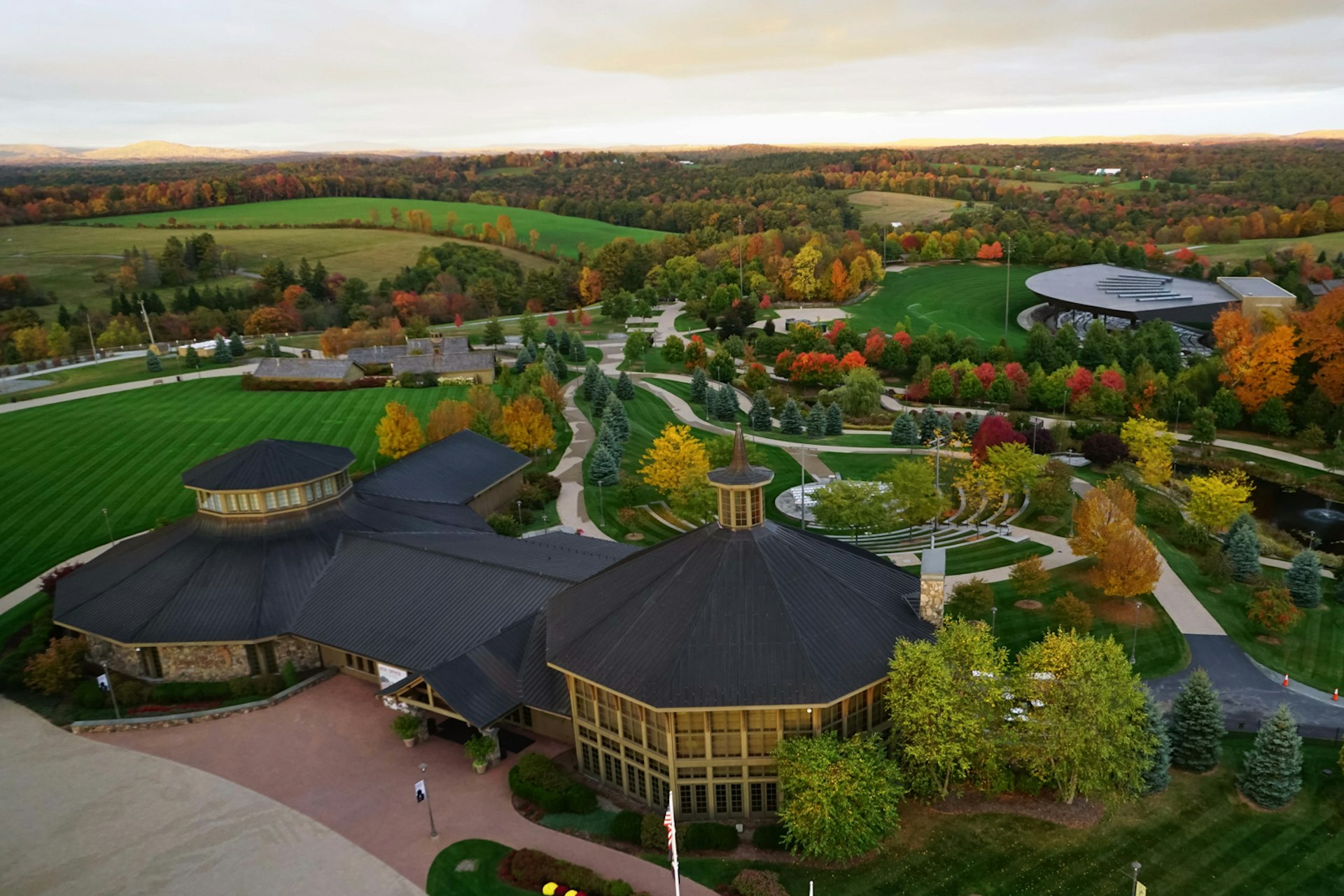 Overhead view of buildings and green rolling hills; summer trips from New York City