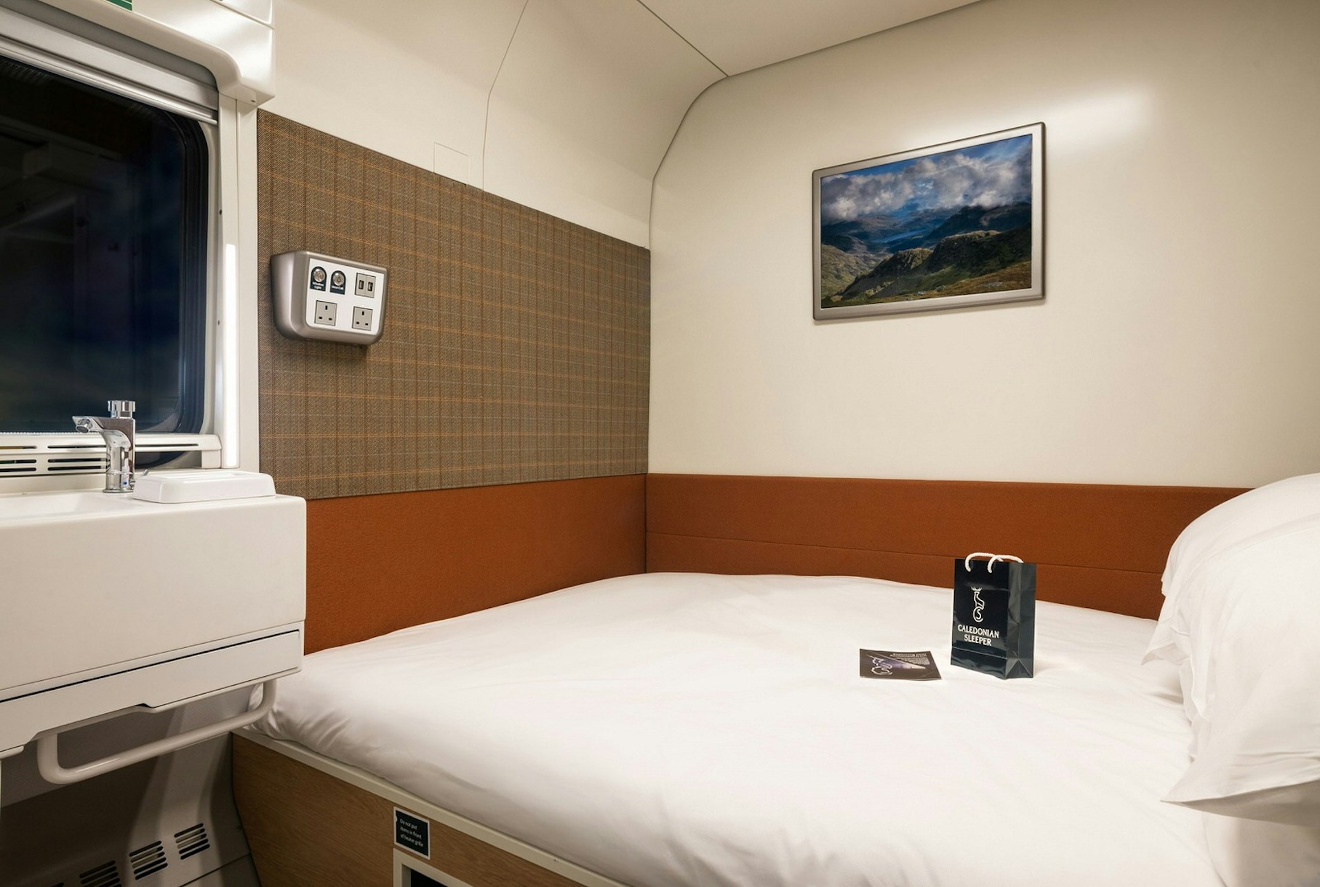 The interior of a double cabin on the Caledonian Sleeper, with sink and large double bed visible