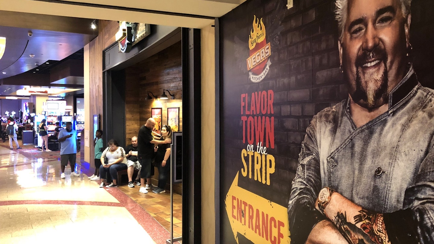 A large mural of celebrity chef Guy Fieri points the way to his restaurant in a Las Vegas casino
