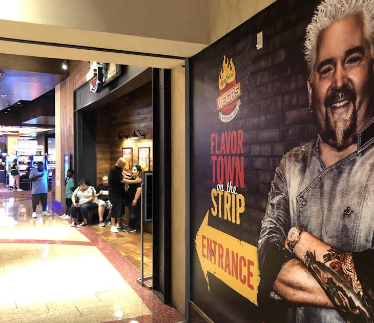 A large mural of celebrity chef Guy Fieri points the way to his restaurant in a Las Vegas casino