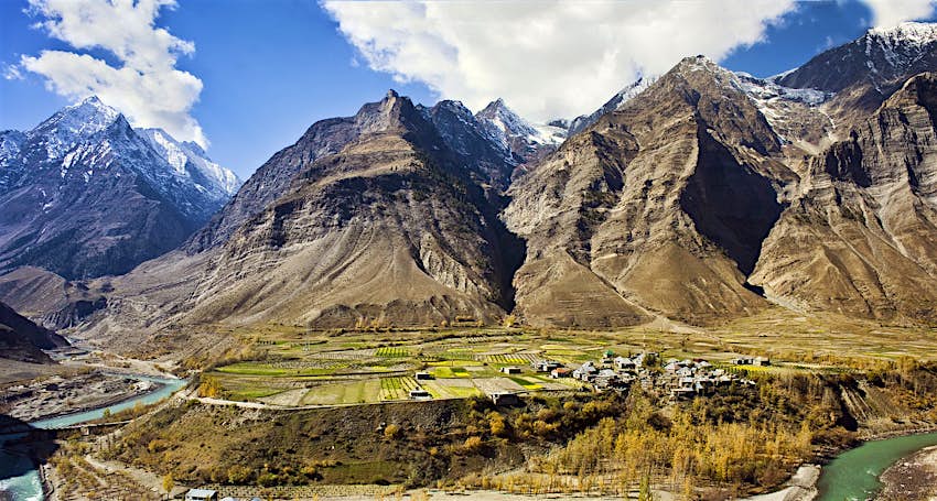 A small village sits in the shadow of hulking mountains of India's Lahaul valley in the Himalayas