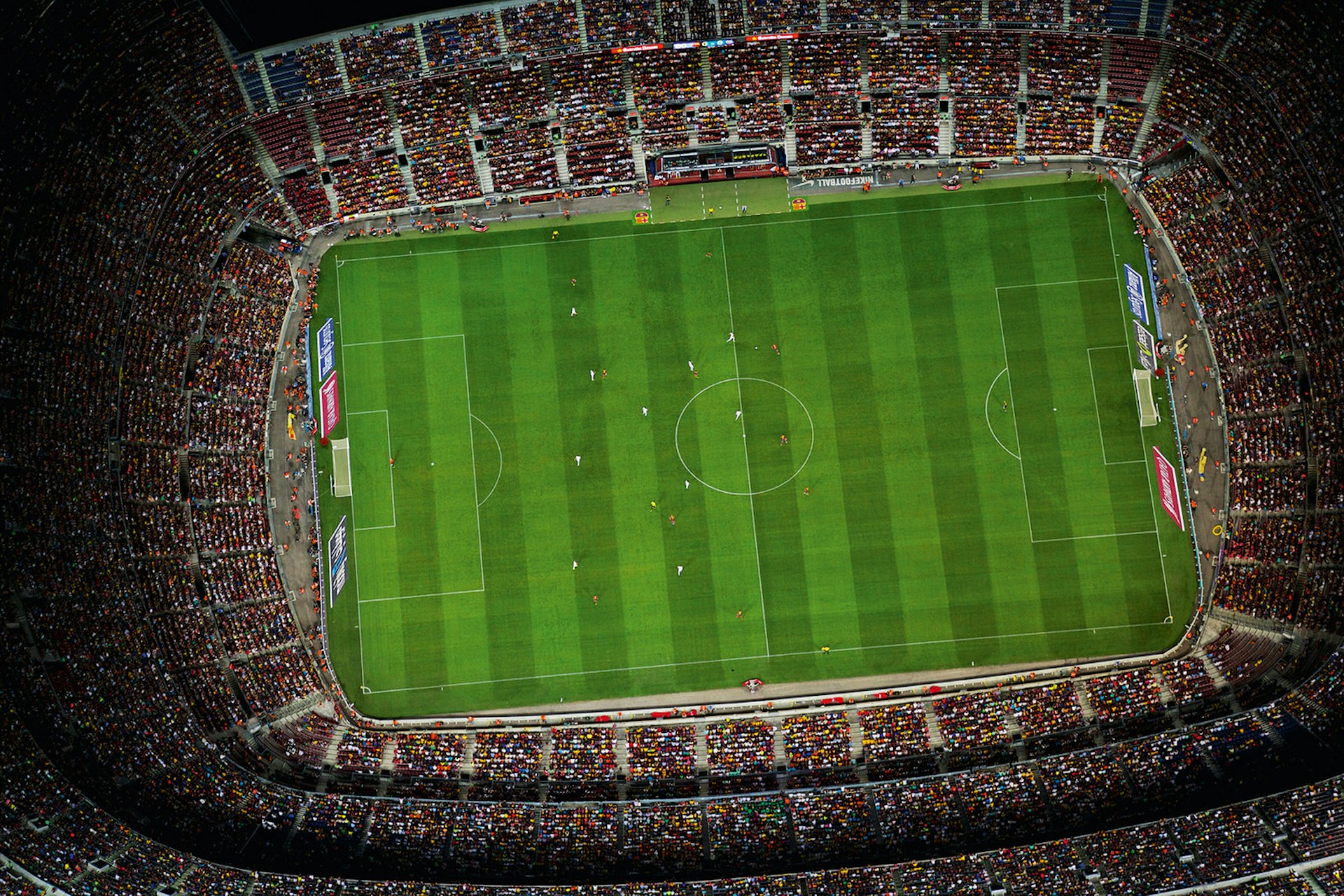 Camp Nou stadium as shown from above with the pitch encircled by a sell-out crowd. Rivalries in sport