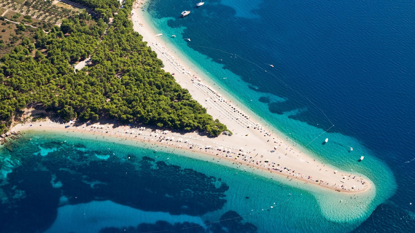 Aerial photograph of the beach, which comes out in a spit of land from the peninsula.
