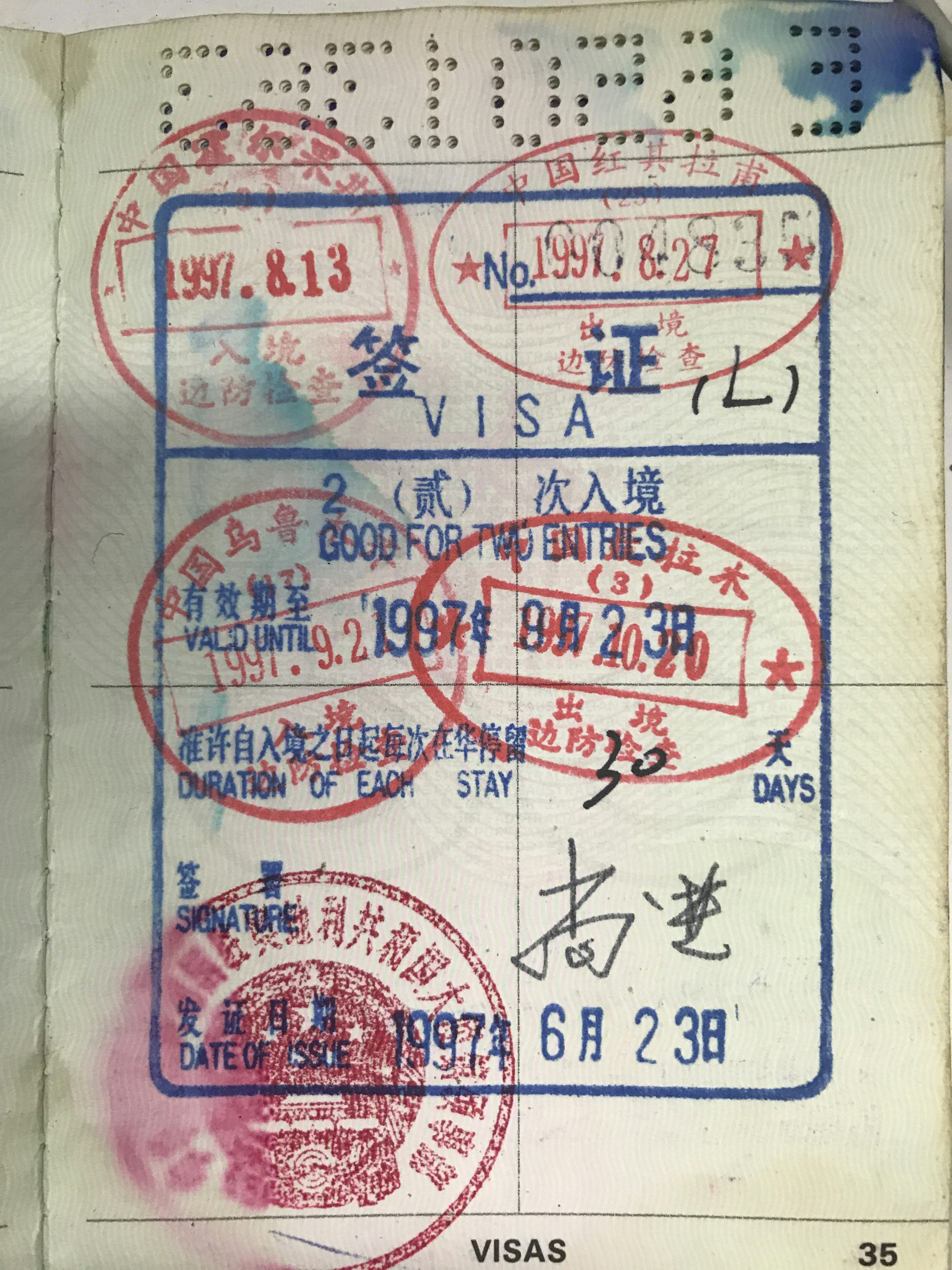 An old passport page showing Chinese double-entry visa stamps