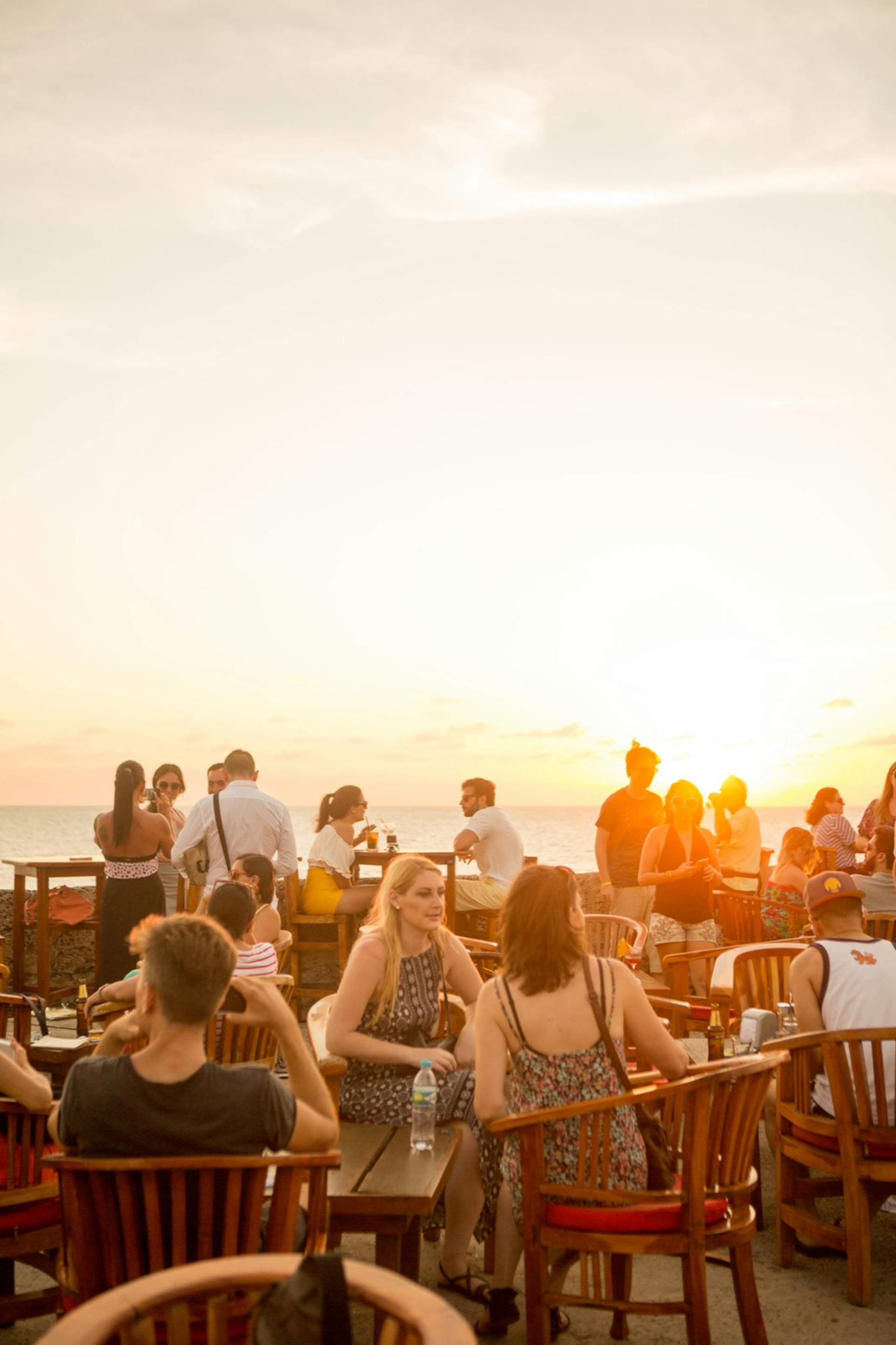 Patrons watch the sunset from the sea wall in the Old Town neighborhood in Cartagena, Colombia.