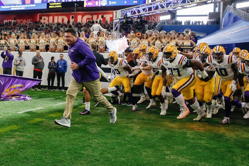 LSU Tigers head coach Ed Orgeron leads his team onto the football field before a LSU game; day trips New Orleans 