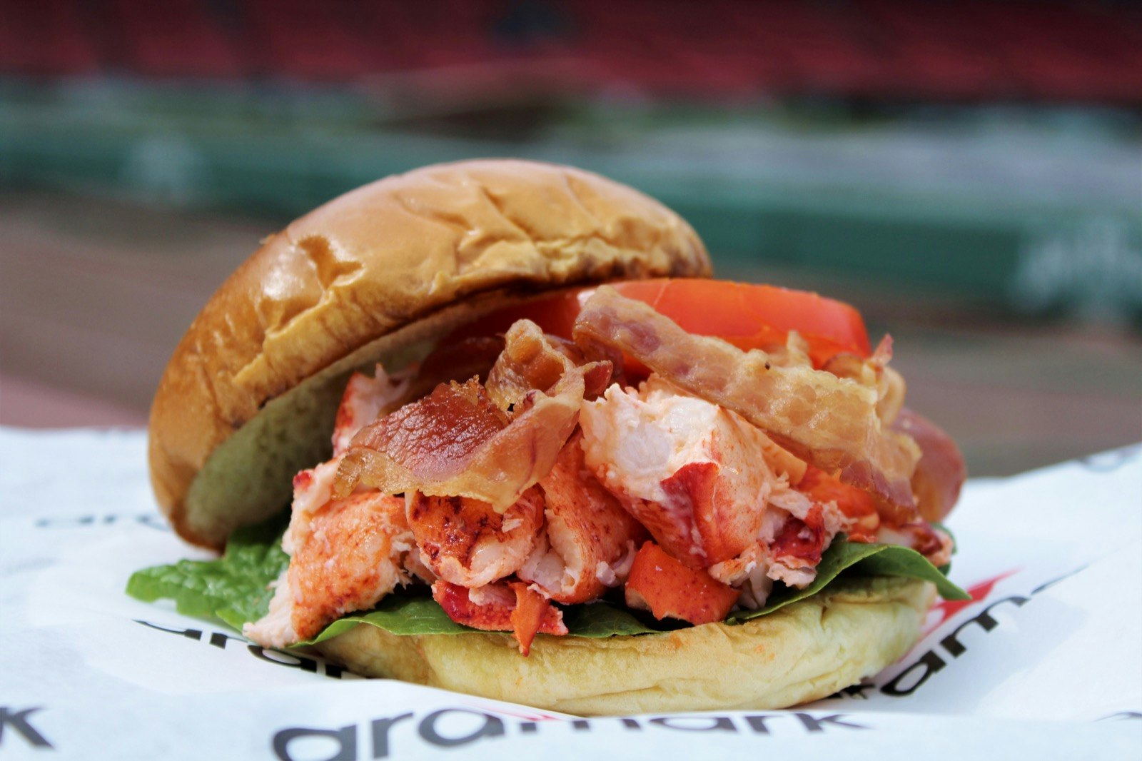 A lobster rolL BLT on a paper wrapper