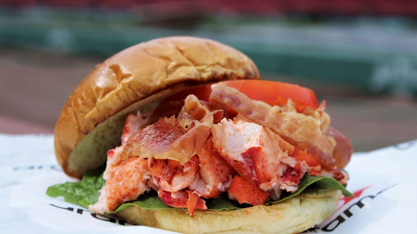 A lobster rolL BLT on a paper wrapper