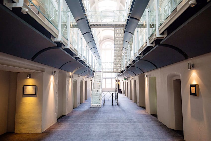 The brilliantly lit atrium of the prison converted into a hotel.