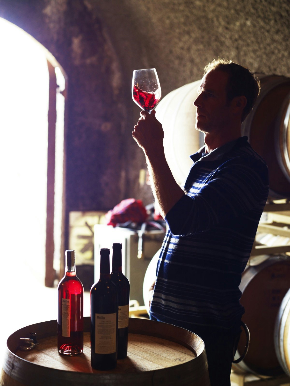 Owner of Bella Winery in Dry Creek Valley sampling a red Sonoma zinfandel.