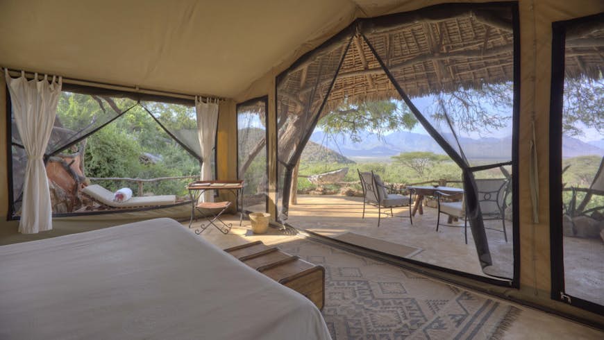 A luxury tent on a Kenyan field, with blue skies overhead; all-inclusive resort adventures