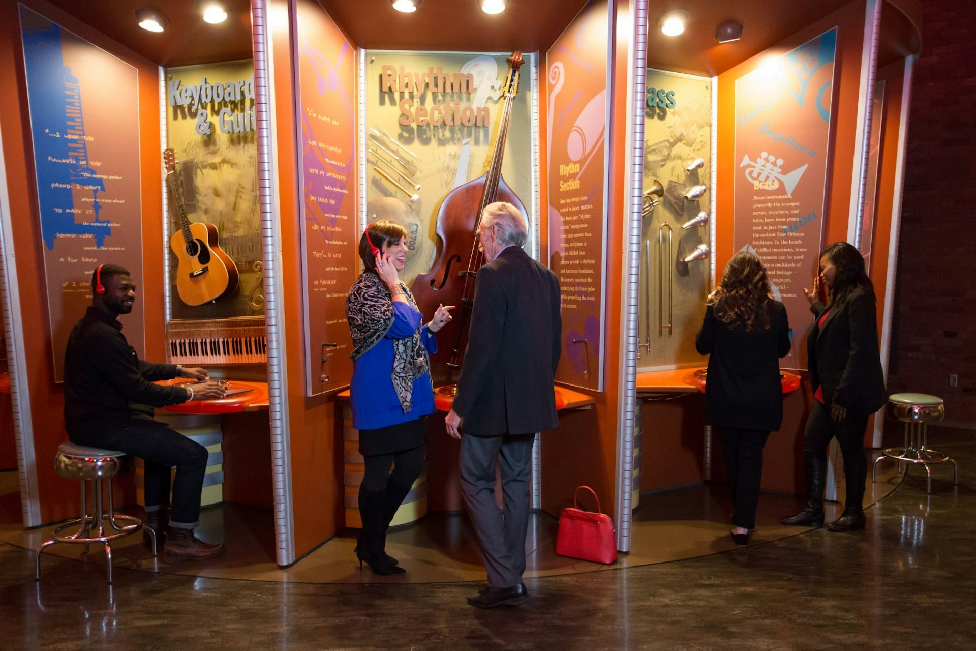 People stand listening to headphones inside the American Jazz Museum. USA museums for music lovers