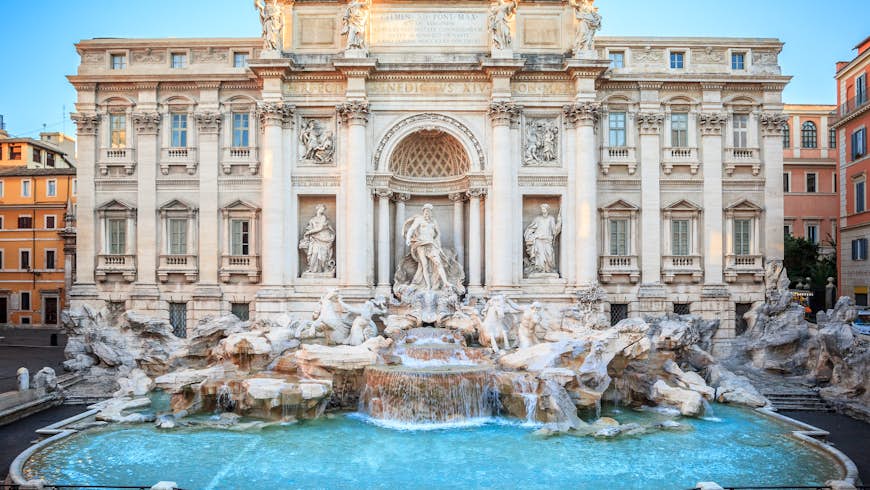 The blue waters of Trevi Fountain are backed by the grandiose Baroque sculptures and mansion-like facade