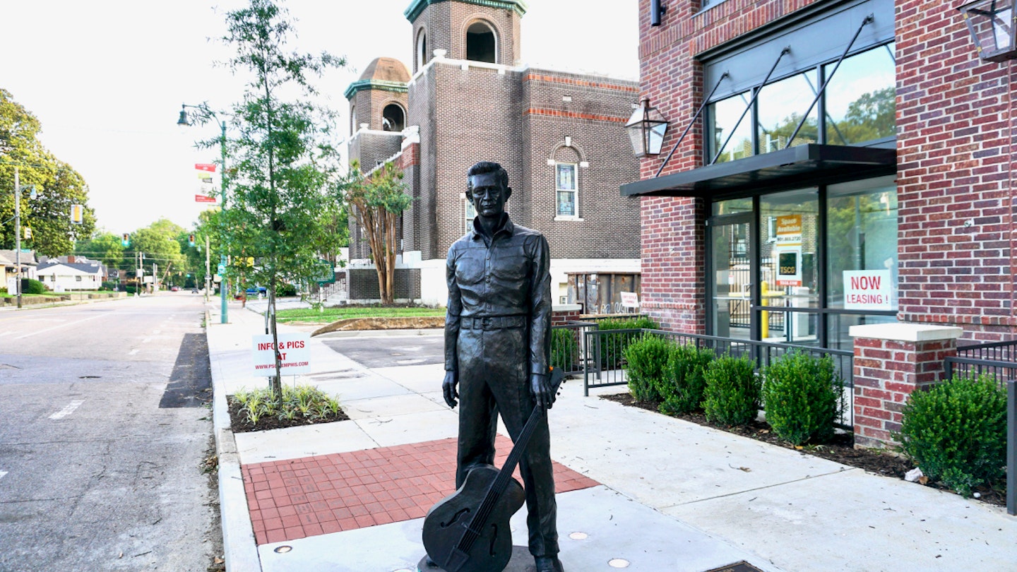 Statue of a young Johnny Cash, guitar in hand