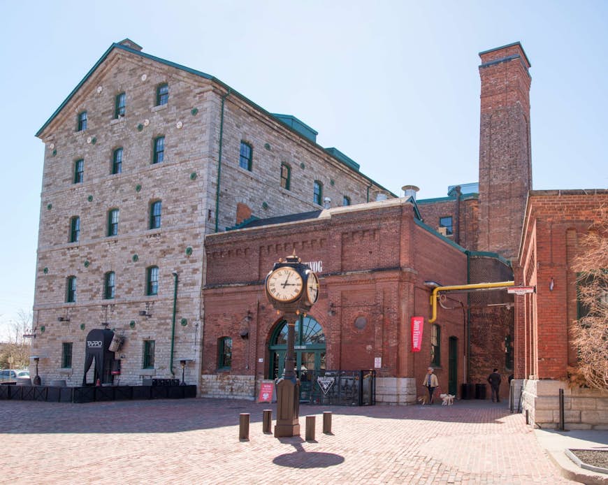 Colonial buildings sit behind a vintage black street clock with Roman numerals in Toronto's Distillery District; Weekend in Toronto