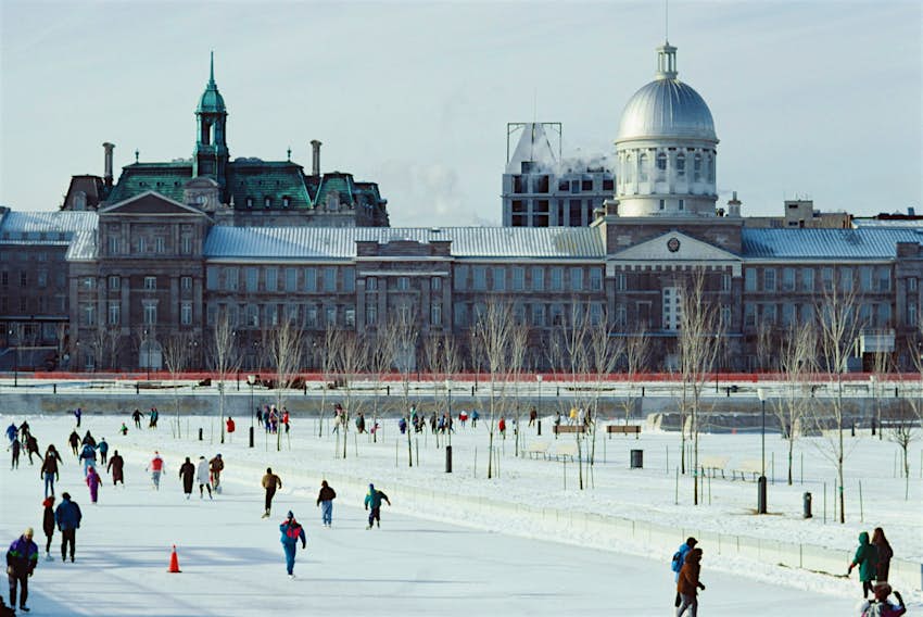 People ice skate on an outdoor rink in the Old Port of Montréal