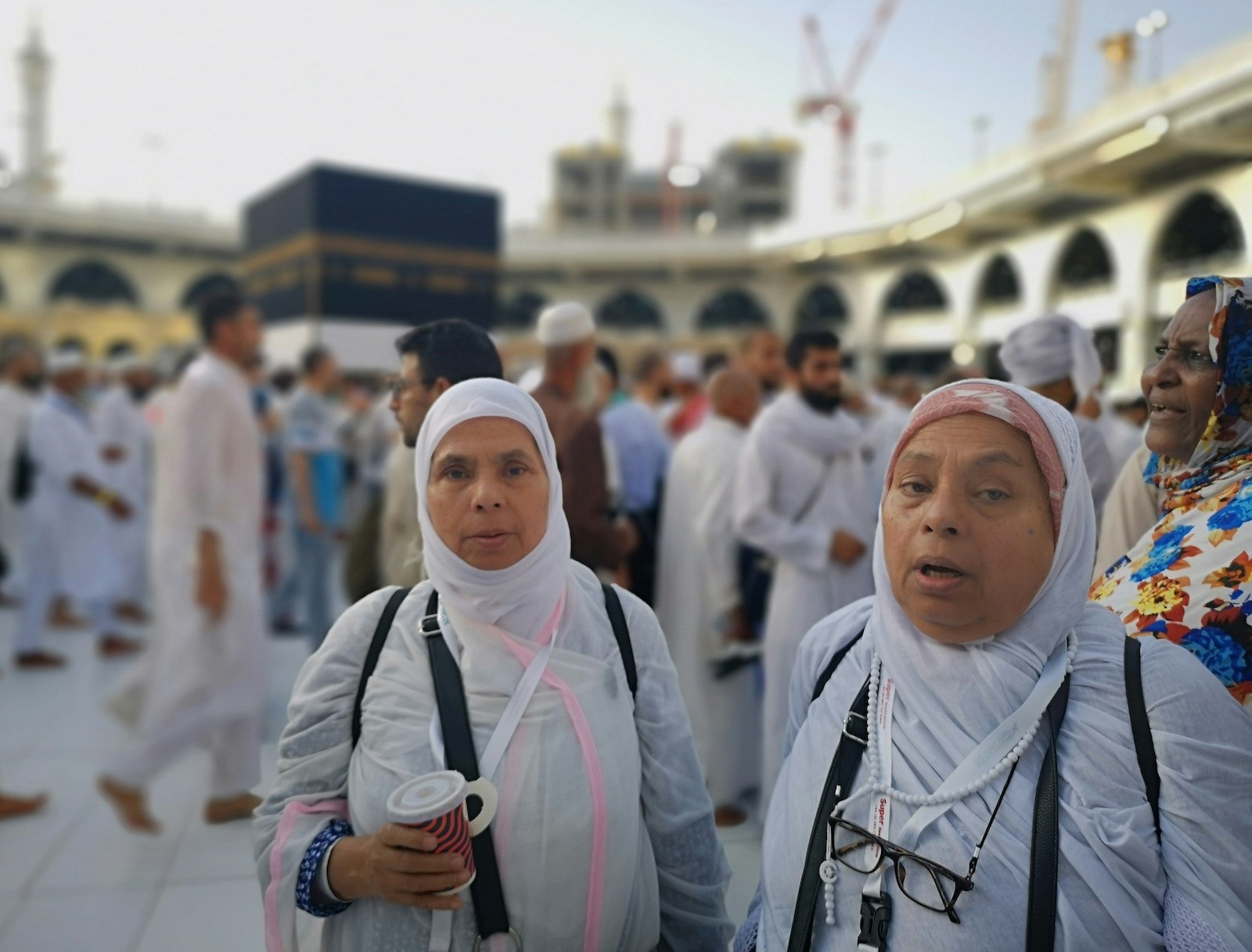 L-R: Tharik's mother and her twin sister standing before the Kaaba and surrounded by other pilgrims. Hajj diaries