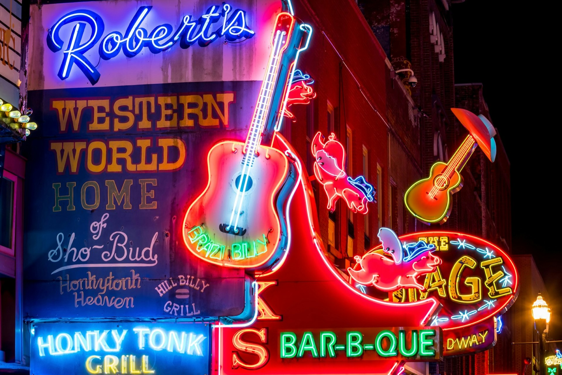 Neon signs shine on the streets on lower Broadway area; weekend Nashville 