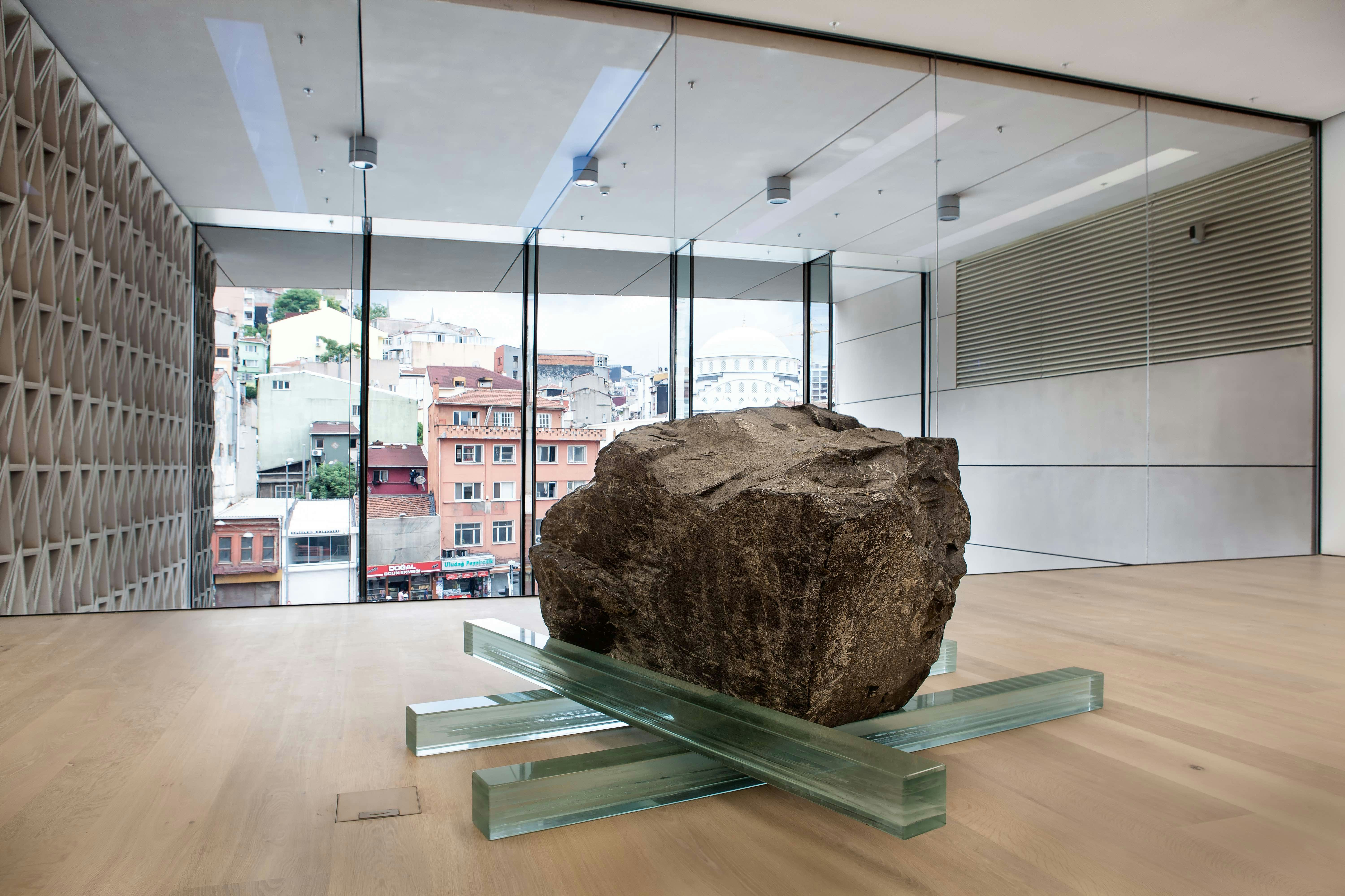 Large rock standing in exhibition space by window.jpg