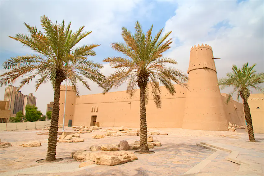 Masmak Fortress Sand-coloured fortress with palm trees in the foreground