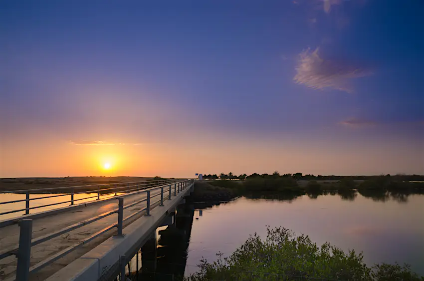 Kalba Bridge The Kalba Bridge stretching across periwinkle water at sunset