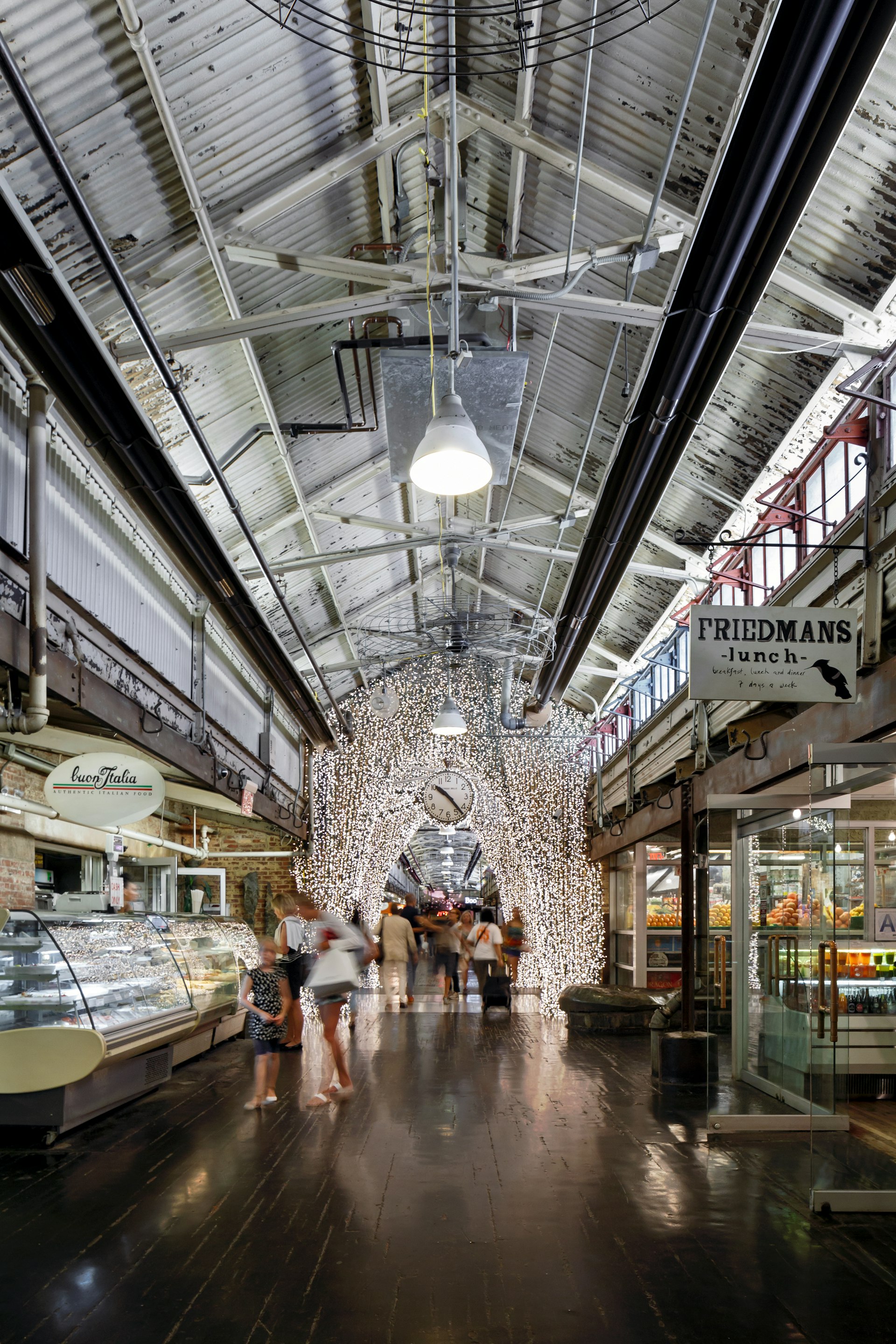 Inside a former industrial building turned food hall, with bright lights and cool shops