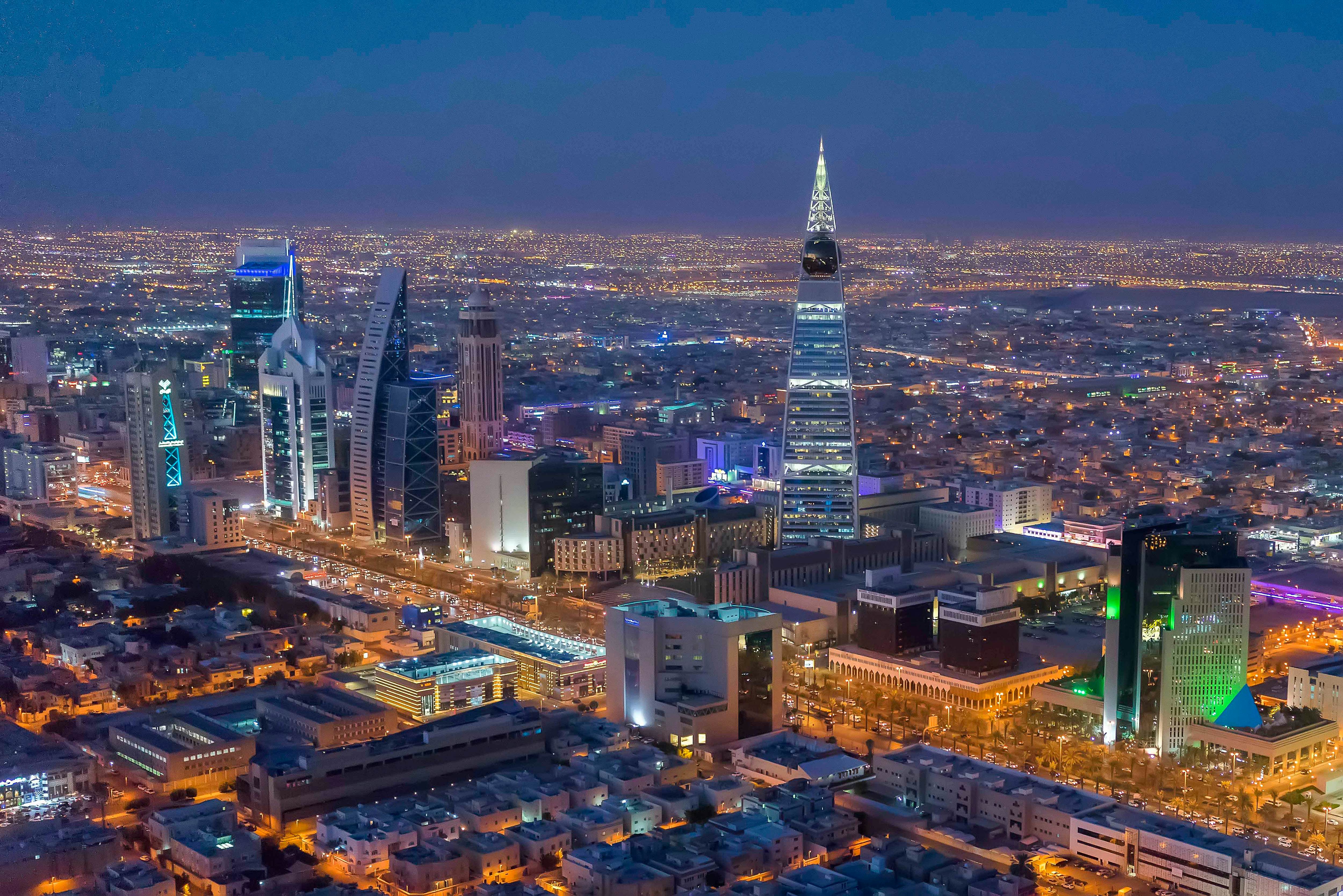 Saudi Arabia skyline at night with an illuminated pointed tower