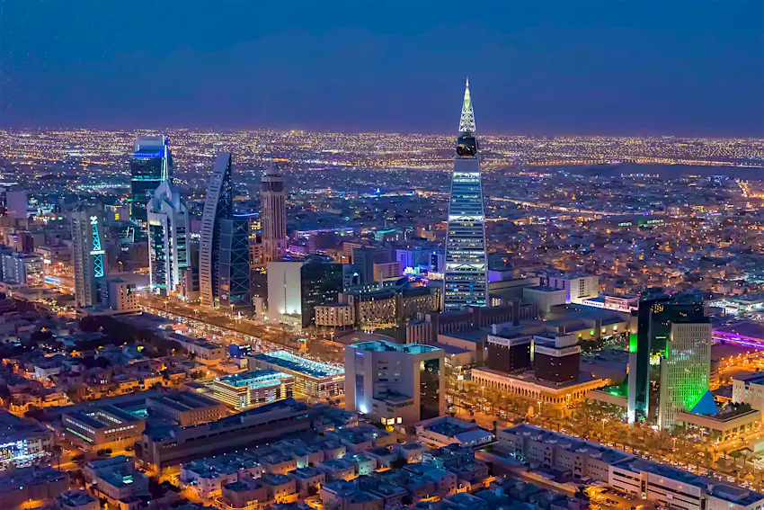 Faisaliah Tower Saudi Arabia skyline at night with an illuminated pointed tower