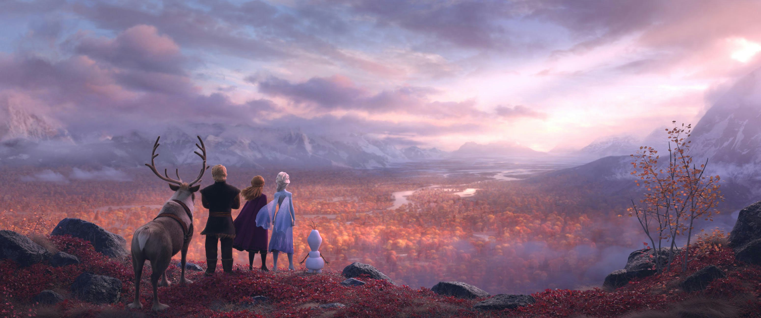 The cast of Frozen 2 overlook a gloomy, autumn forest