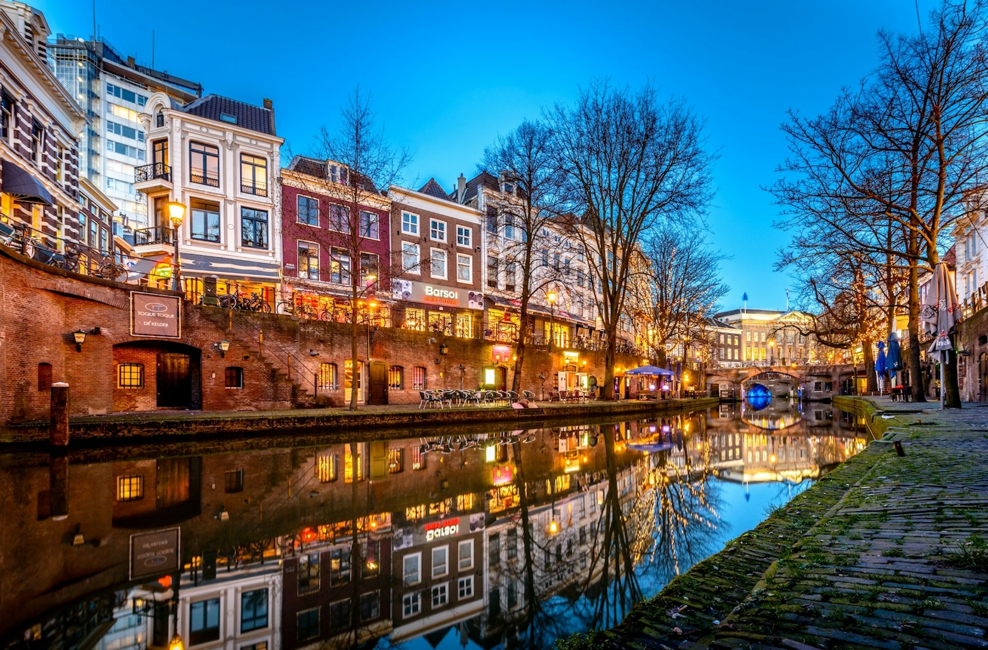 The canalside in Utrecht is lit up at dusk; Copenhagen alternatives