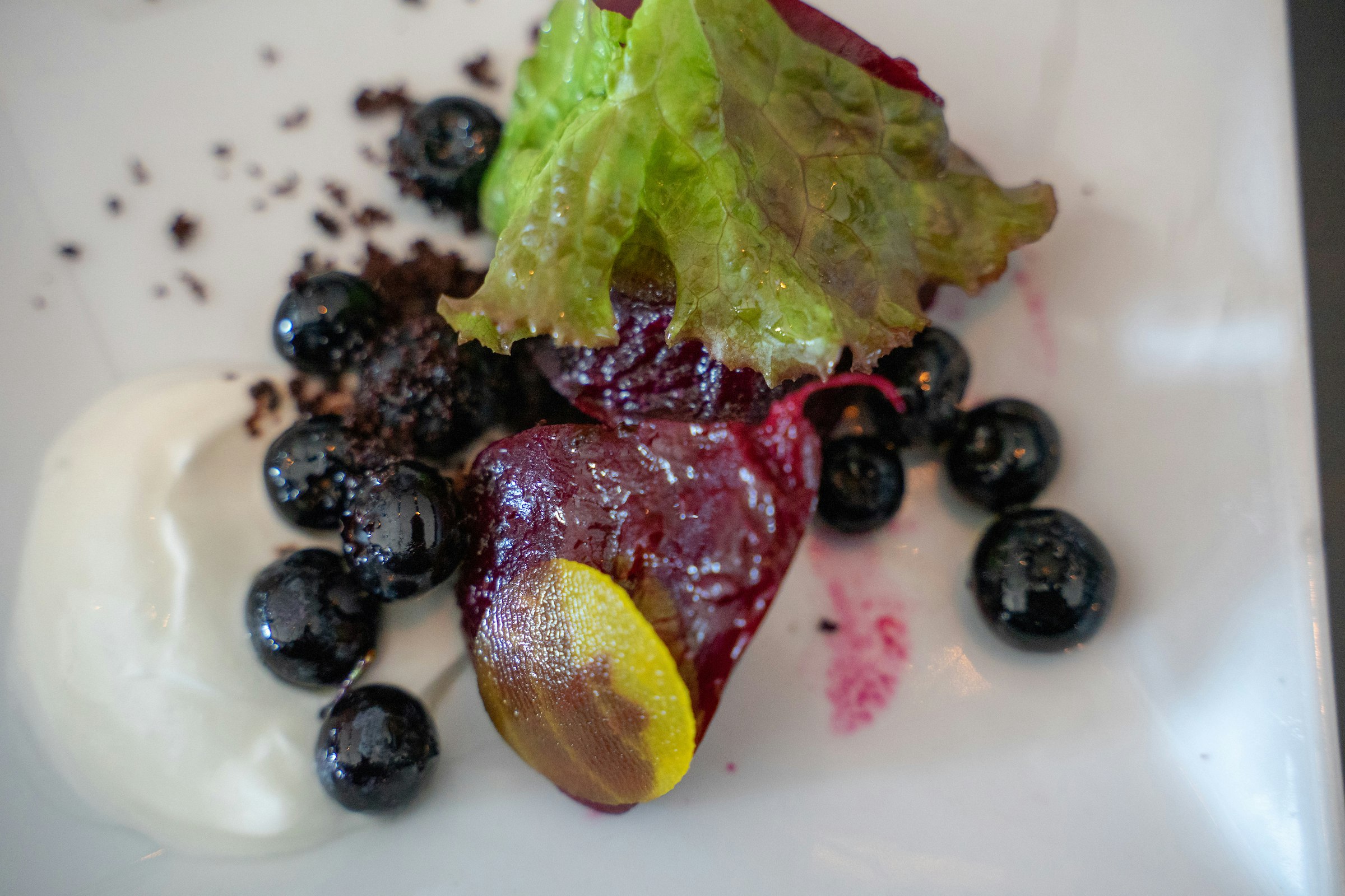 A brightly hued close-up shot of a blueberry and beet salad at Evo Kitchen + Bar in Portlane, Maine