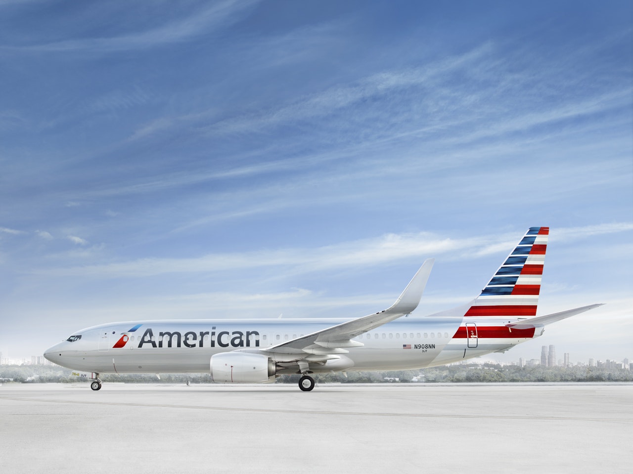 Exterior of an American Airlines Boeing 737-Max plane in front of a cloudy blue sky