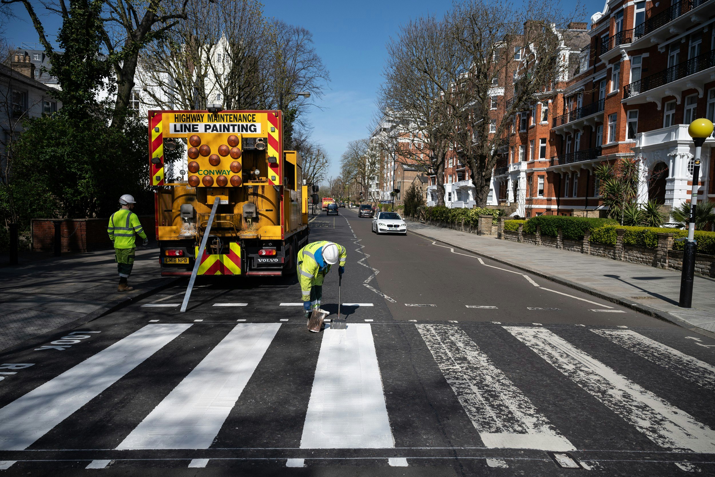 A Highways Maintenance team takes advantage of the COVID-19 coronavirus lockdown to re-paint the iconic Abbey Road crossing.jpg