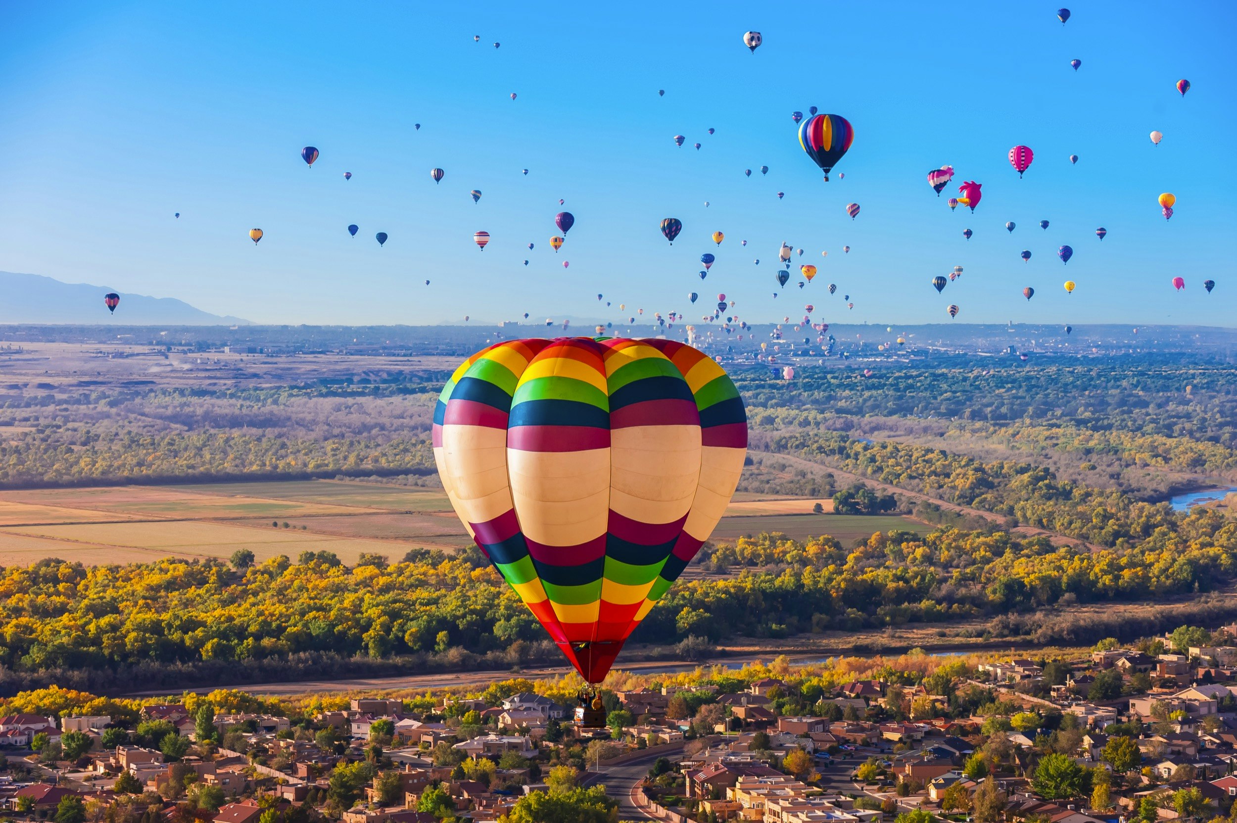 Aerial view, hot air balloons flying during the Albuquerque International Balloon Fiesta, Albuquerque, New Mexico USA.