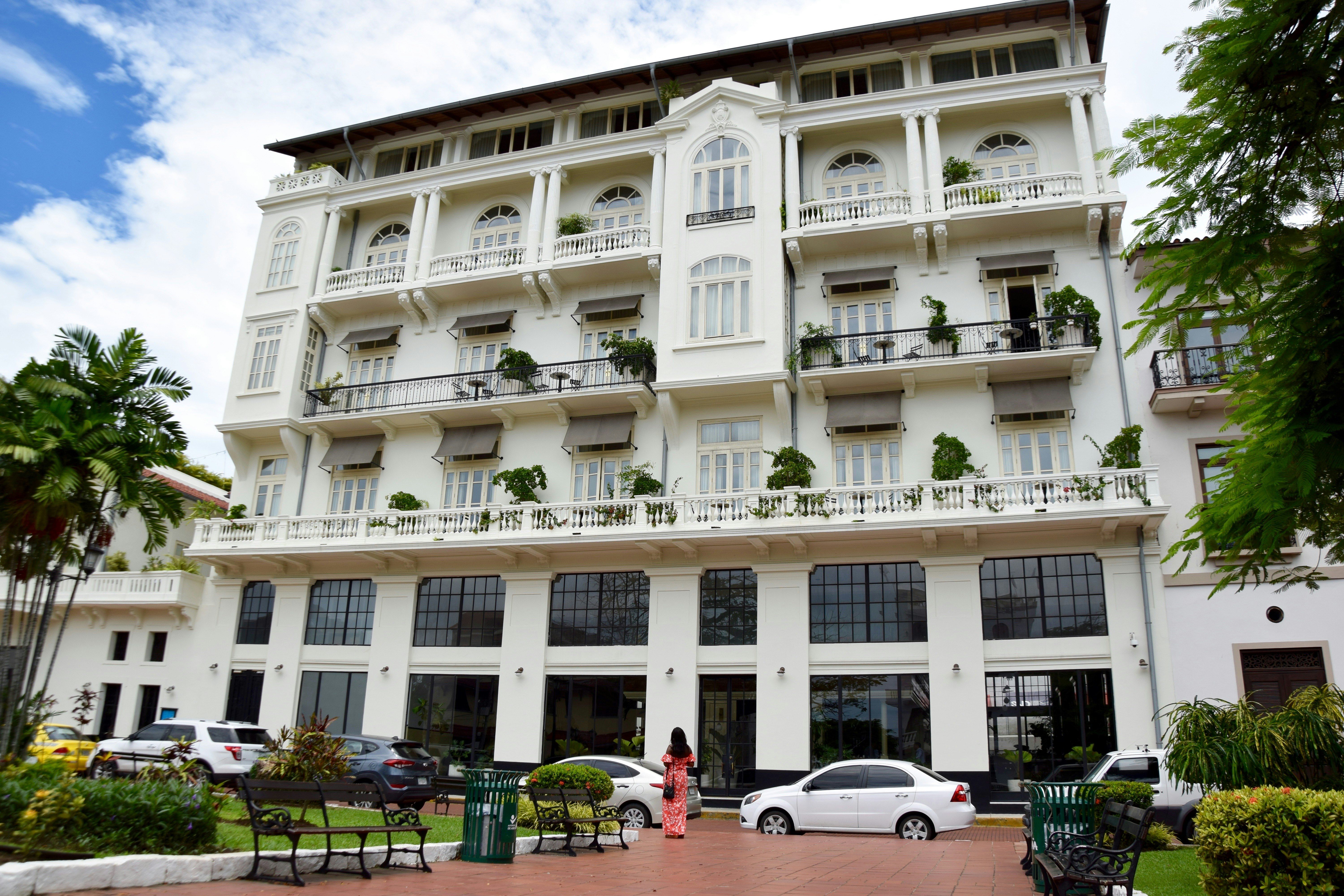 A woman stands in front of the American Trade Hotel in Panama; perfect weekend Panama 