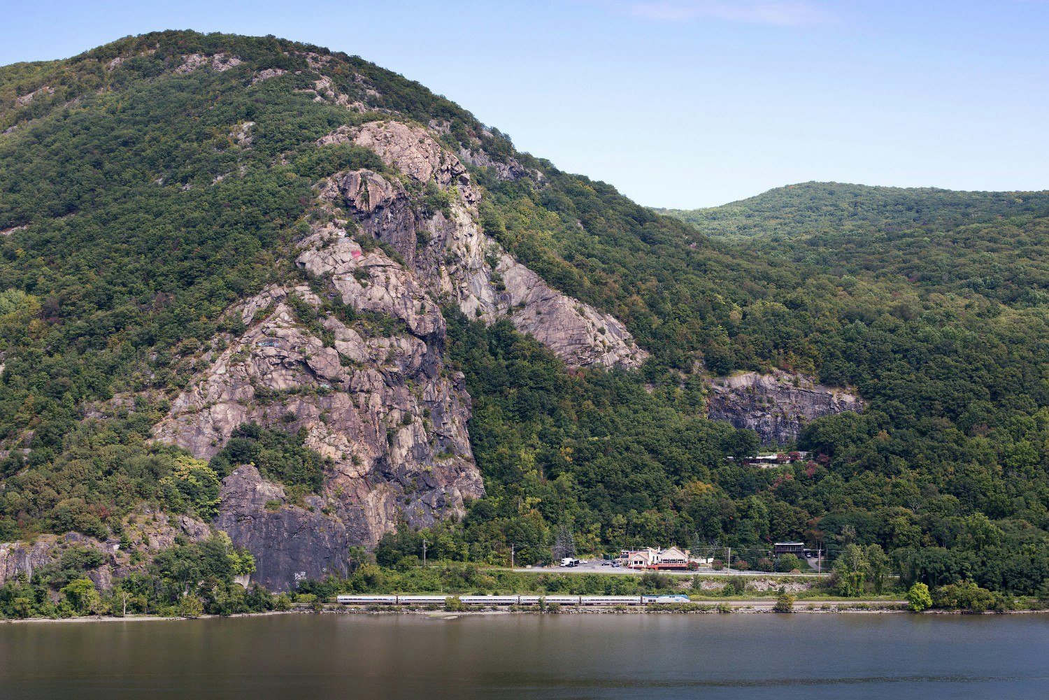 Empire Service train passes alongside Breakneck Ridge in the Hudson Highlands near Beacon, New York