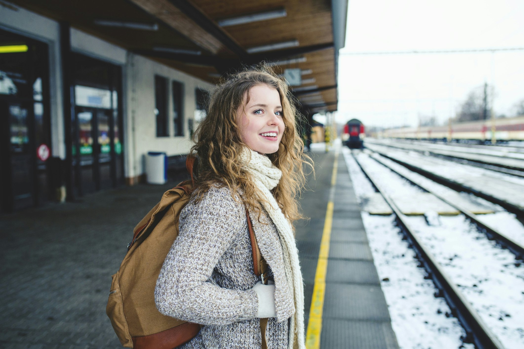 Smiling teenage girl on station platform 