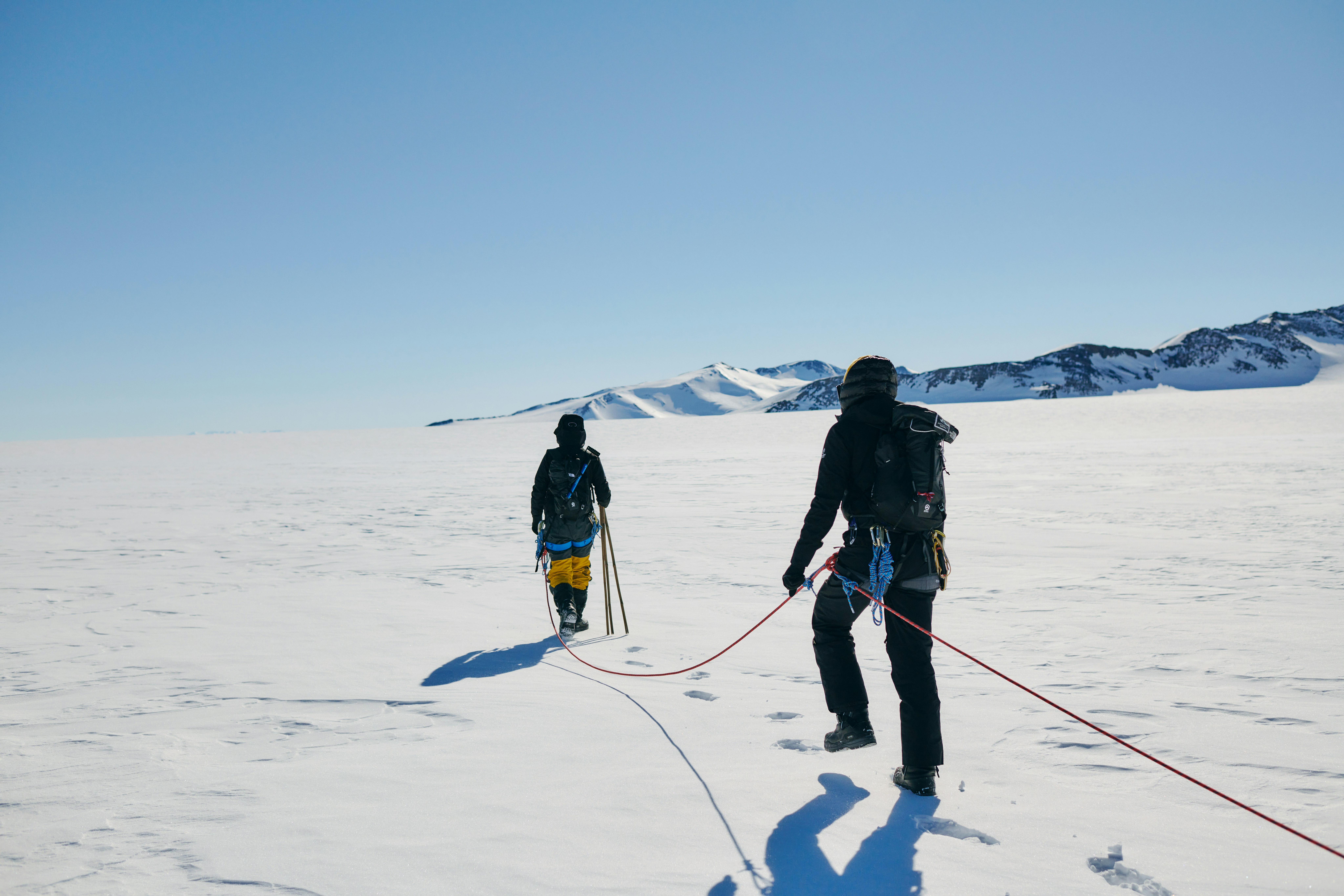 Two women tethered together by rope as they embark on Antarctic expedition
